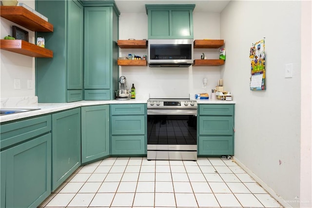 275 Violeta St, San Benito, TX 78586 - kitchen featuring open shelves, appliances with stainless steel finishes, light countertops, and baseboards