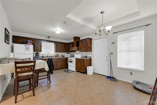 115 W Albatross Ave, Pharr, TX 78577 - kitchen featuring visible vents, dark brown cabinetry, white appliances, a chandelier, and decorative light fixtures