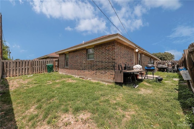 115 W Albatross Ave, Pharr, TX 78577 - view of property exterior with a yard, brick siding, and a fenced backyard