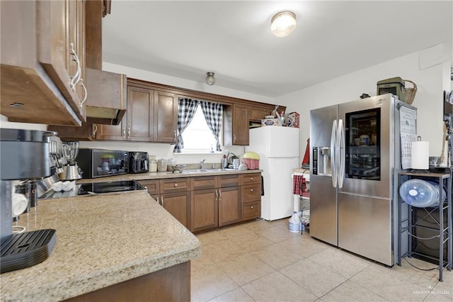 115 W Albatross Ave, Pharr, TX 78577 - kitchen featuring black microwave, a sink, light countertops, freestanding refrigerator, and stainless steel refrigerator with ice dispenser