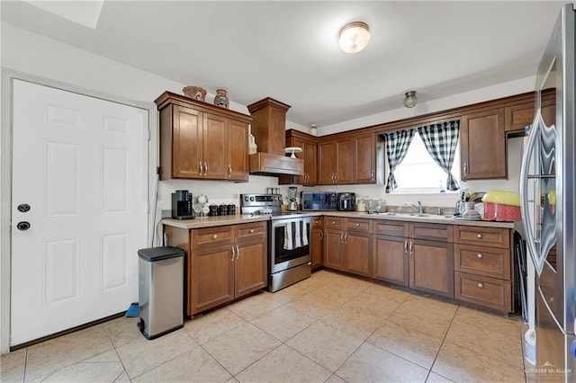 115 W Albatross Ave, Pharr, TX 78577 - kitchen featuring light countertops, brown cabinets, a sink, appliances with stainless steel finishes, and light tile patterned floors