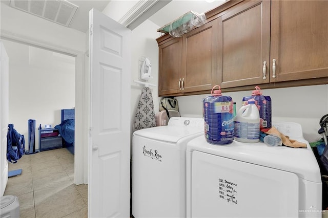115 W Albatross Ave, Pharr, TX 78577 - laundry room featuring washing machine and clothes dryer, visible vents, light tile patterned floors, and cabinet space
