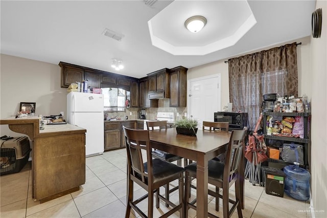 115 W Albatross Ave, Pharr, TX 78577 - dining room with light tile patterned floors, a tray ceiling, and visible vents