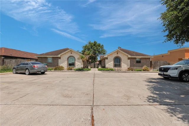 115 W Albatross Ave, Pharr, TX 78577 - view of front of property with uncovered parking, fence, and stone siding