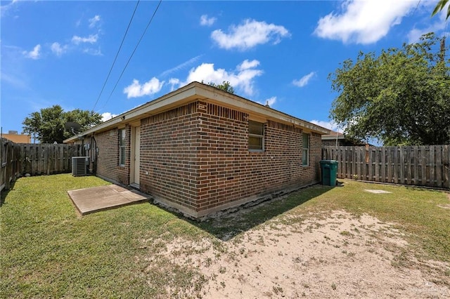 115 W Albatross Ave, Pharr, TX 78577 - view of side of property featuring brick siding, a fenced backyard, a yard, and cooling unit