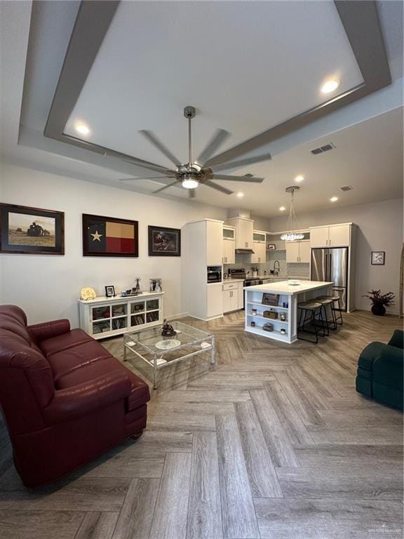 living room with light parquet floors and ceiling fan