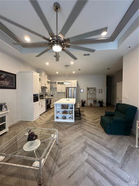 living room featuring sink, parquet floors, and ceiling fan