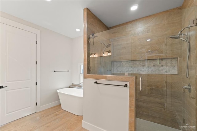 bathroom featuring hardwood / wood-style flooring and independent shower and bath