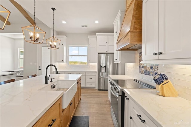 kitchen with white cabinetry, pendant lighting, stainless steel appliances, and custom exhaust hood