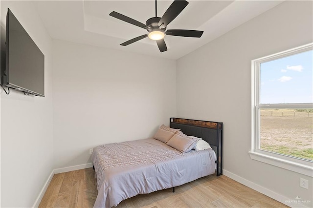 bedroom with ceiling fan and light hardwood / wood-style flooring