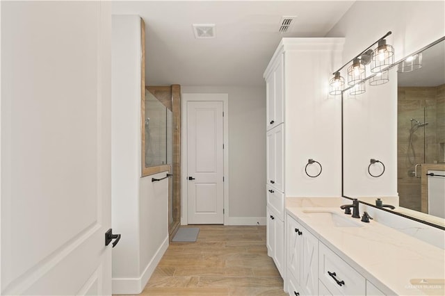 bathroom with vanity, hardwood / wood-style flooring, and walk in shower