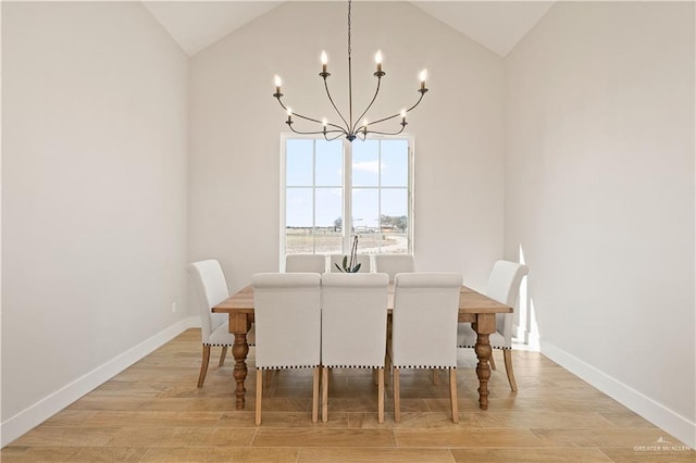 dining room featuring vaulted ceiling, an inviting chandelier, and light hardwood / wood-style flooring