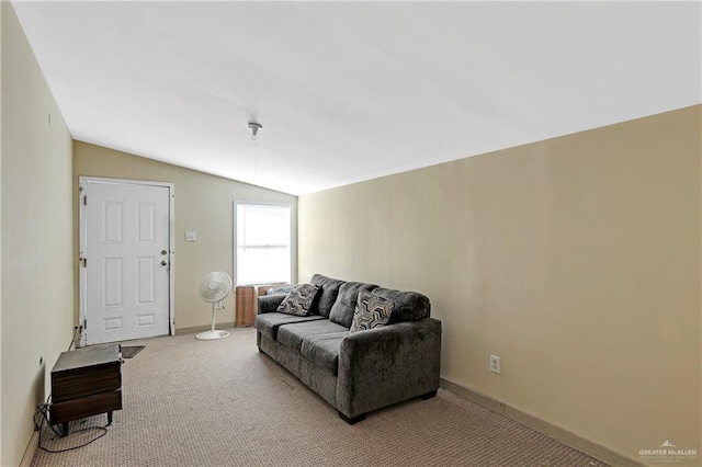 carpeted living room featuring vaulted ceiling