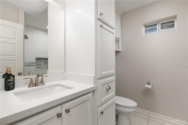 bathroom with vanity, tile patterned floors, toilet, and walk in shower