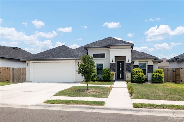 view of front of house with a garage and a front lawn