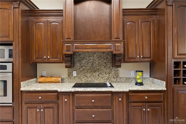 kitchen with light stone counters, appliances with stainless steel finishes, extractor fan, and backsplash