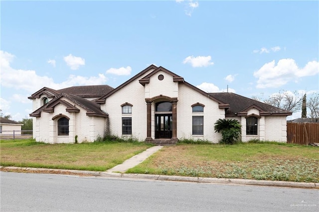 french country home featuring a front yard