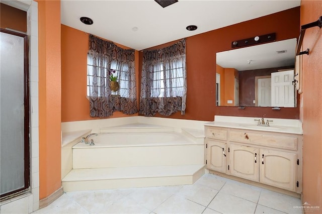 bathroom with tile patterned floors, vanity, and a tub