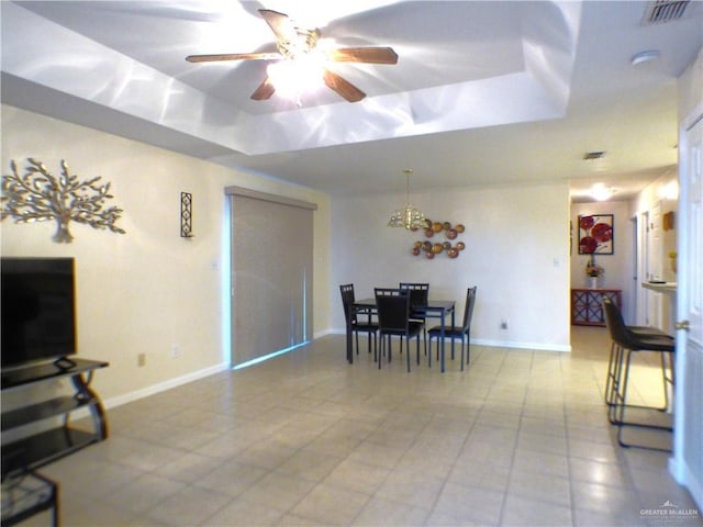 dining room featuring visible vents, light tile patterned floors, a raised ceiling, and ceiling fan with notable chandelier