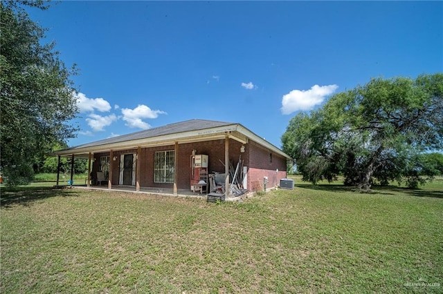 1806 N Doolittle Rd, Edinburg, TX 78542 - rear view of house featuring a lawn, brick siding, and a patio area