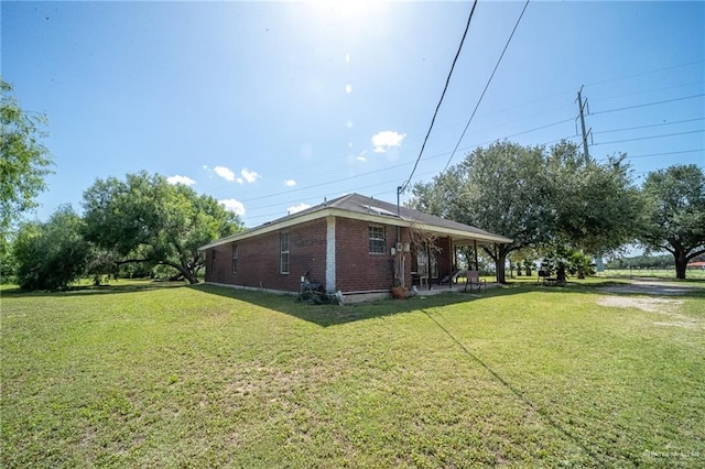 1806 N Doolittle Rd, Edinburg, TX 78542 - view of side of property featuring a yard and brick siding