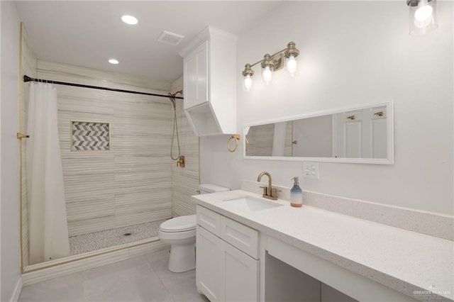 bathroom with vanity, toilet, and walk in shower