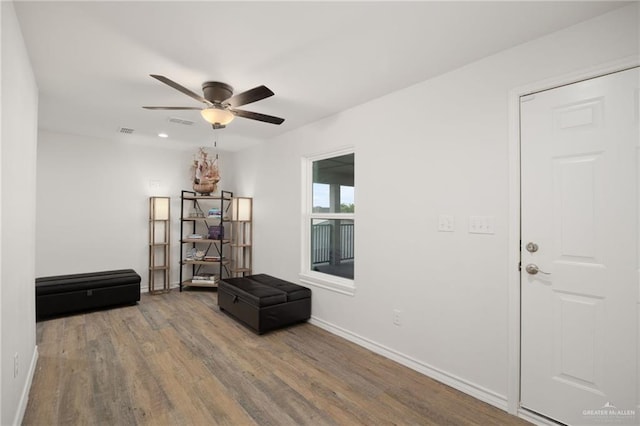 unfurnished room with ceiling fan and wood-type flooring