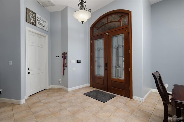 2513 Kings Dr, Edinburg, TX 78539 - entrance foyer with french doors, light tile patterned floors, and baseboards