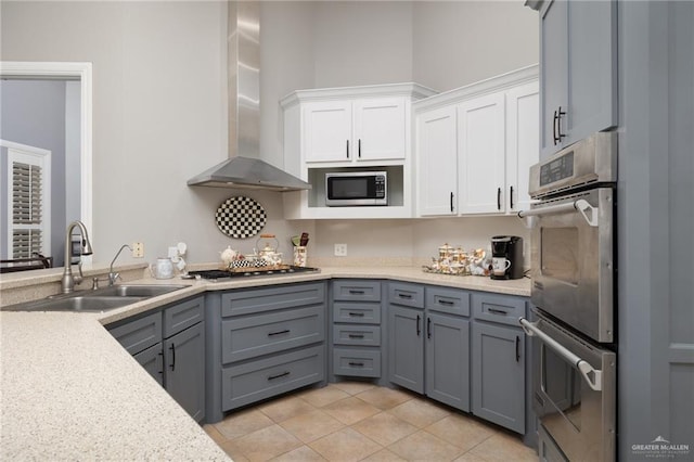 2513 Kings Dr, Edinburg, TX 78539 - kitchen with wall chimney range hood, appliances with stainless steel finishes, a sink, and light countertops