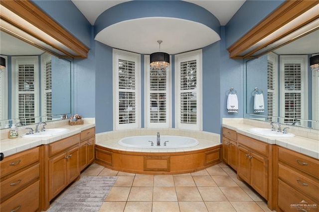 2513 Kings Dr, Edinburg, TX 78539 - bathroom featuring two vanities, a bath, and tile patterned flooring