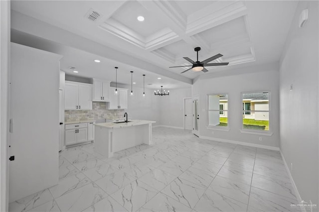kitchen with open floor plan, baseboards, a sink, recessed lighting, and white cabinetry