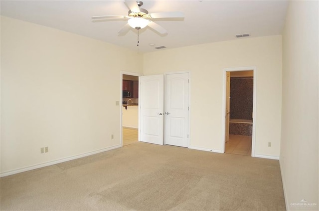 301 Houston St Unit 3303, Port Isabel, TX 78597 - unfurnished bedroom featuring carpet, ensuite bathroom, and ceiling fan