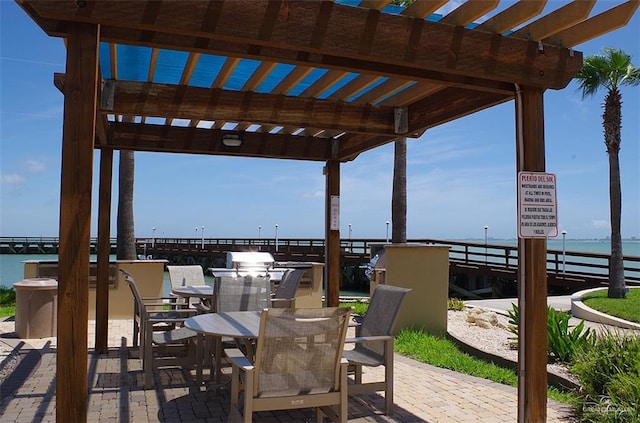 301 Houston St Unit 3303, Port Isabel, TX 78597 - view of patio / terrace featuring a pergola, a water view, and outdoor dining space