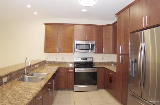 301 Houston St Unit 3303, Port Isabel, TX 78597 - kitchen with appliances with stainless steel finishes, light stone countertops, light tile patterned flooring, recessed lighting, and a peninsula