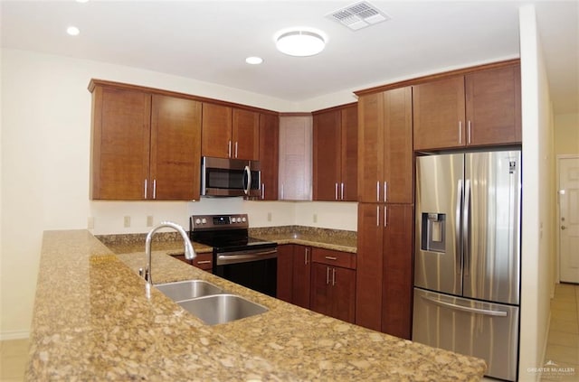301 Houston St Unit 3303, Port Isabel, TX 78597 - kitchen featuring stainless steel appliances, light stone countertops, recessed lighting, and a peninsula
