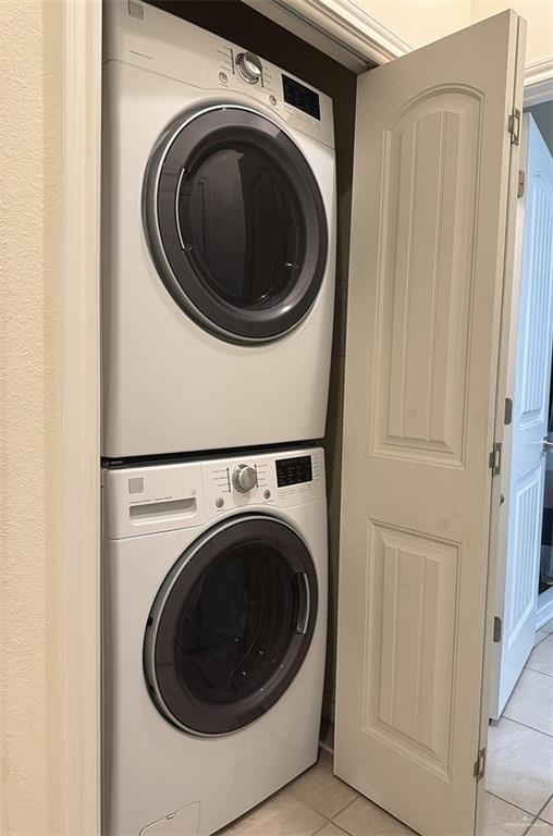301 Houston St Unit 3303, Port Isabel, TX 78597 - laundry room with stacked washer and clothes dryer and light tile patterned floors