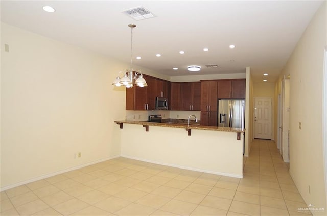 301 Houston St Unit 3303, Port Isabel, TX 78597 - kitchen with appliances with stainless steel finishes, a peninsula, a kitchen bar, a chandelier, and recessed lighting