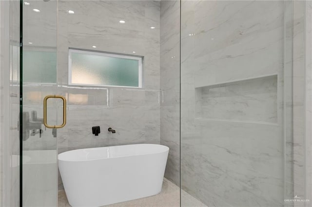 bathroom with a soaking tub and a stall shower
