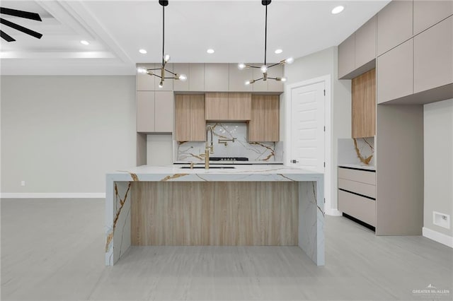 kitchen featuring modern cabinets, recessed lighting, decorative backsplash, baseboards, and a spacious island