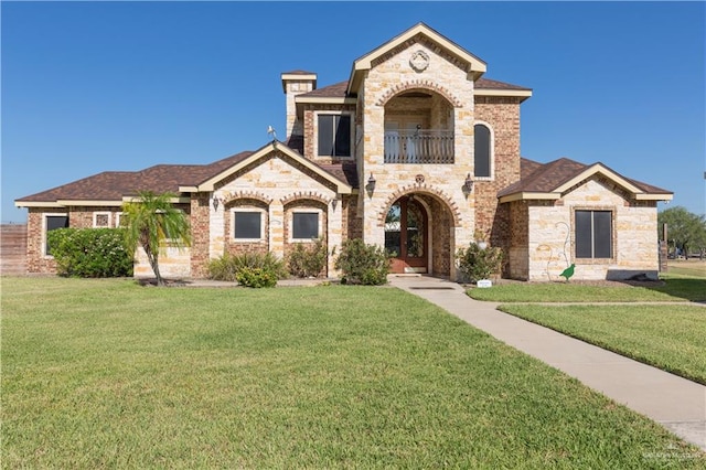 view of front of house with a front yard and a balcony