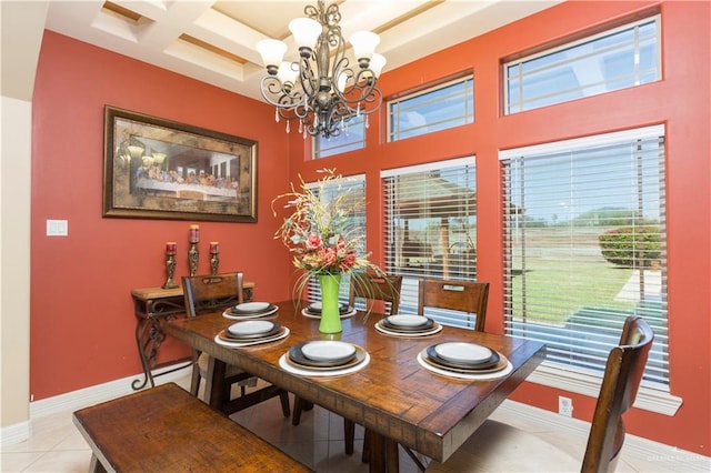 tiled dining room with coffered ceiling and a chandelier