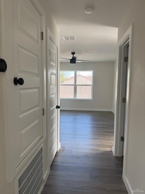 corridor featuring dark hardwood / wood-style flooring