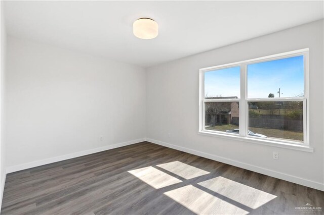 unfurnished room featuring dark wood-type flooring