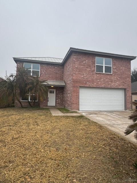 view of property with a garage and a front yard