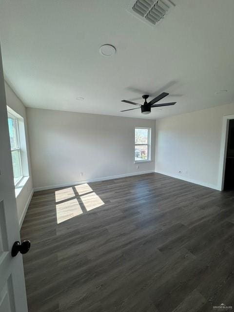 spare room featuring ceiling fan and dark hardwood / wood-style flooring