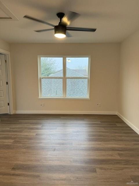 empty room featuring dark wood-type flooring and ceiling fan