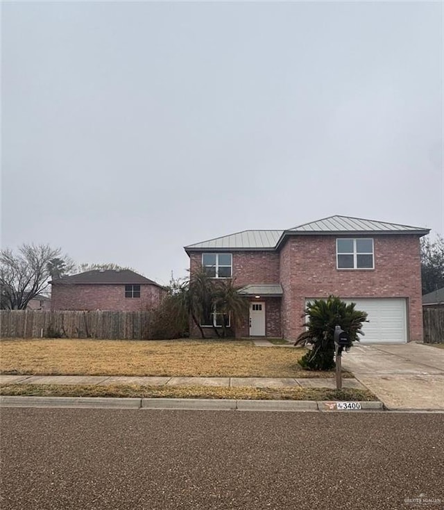 view of front of home featuring a garage and a front yard