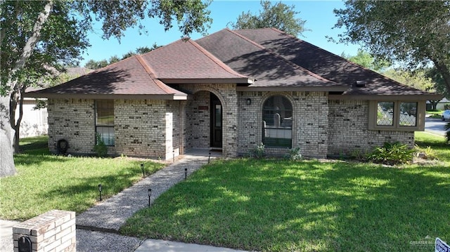 2513 Sandpiper Ave, Mcallen, TX 78504 - view of front facade with brick siding, a front yard, and roof with shingles