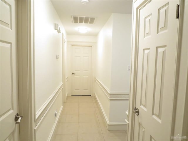 2513 Sandpiper Ave, Mcallen, TX 78504 - corridor featuring light tile patterned flooring and a wainscoted wall
