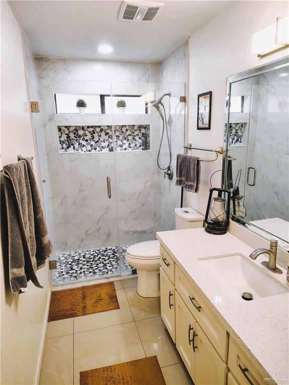 2513 Sandpiper Ave, Mcallen, TX 78504 - full bath featuring toilet, healthy amount of natural light, a shower stall, and vanity